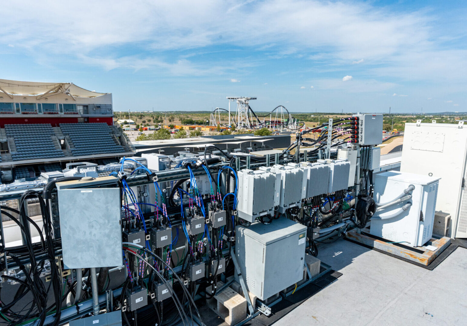 Large industrial cooling units installed on a rooftop under a clear sky.