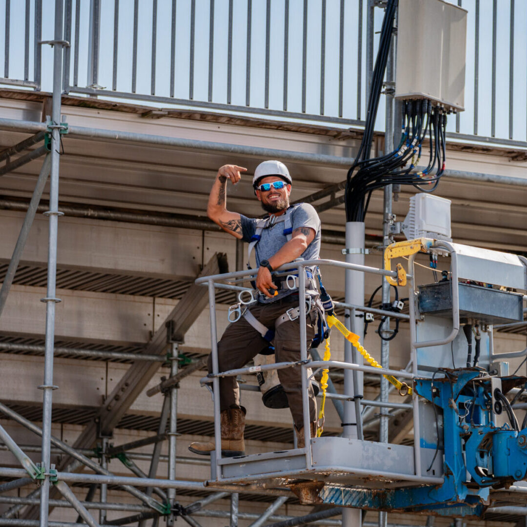 Construction worker using a safety harness on scaffolding.